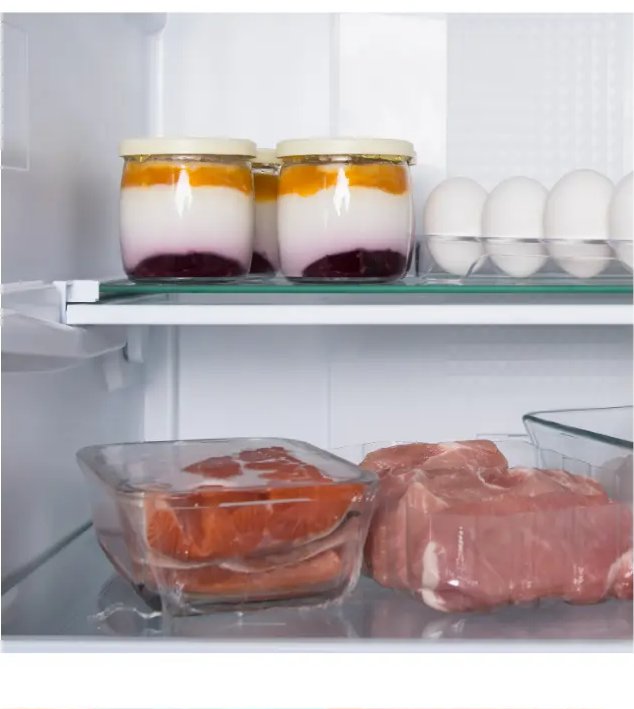 Clean interior of a refrigerator with jars, eggs, and containers